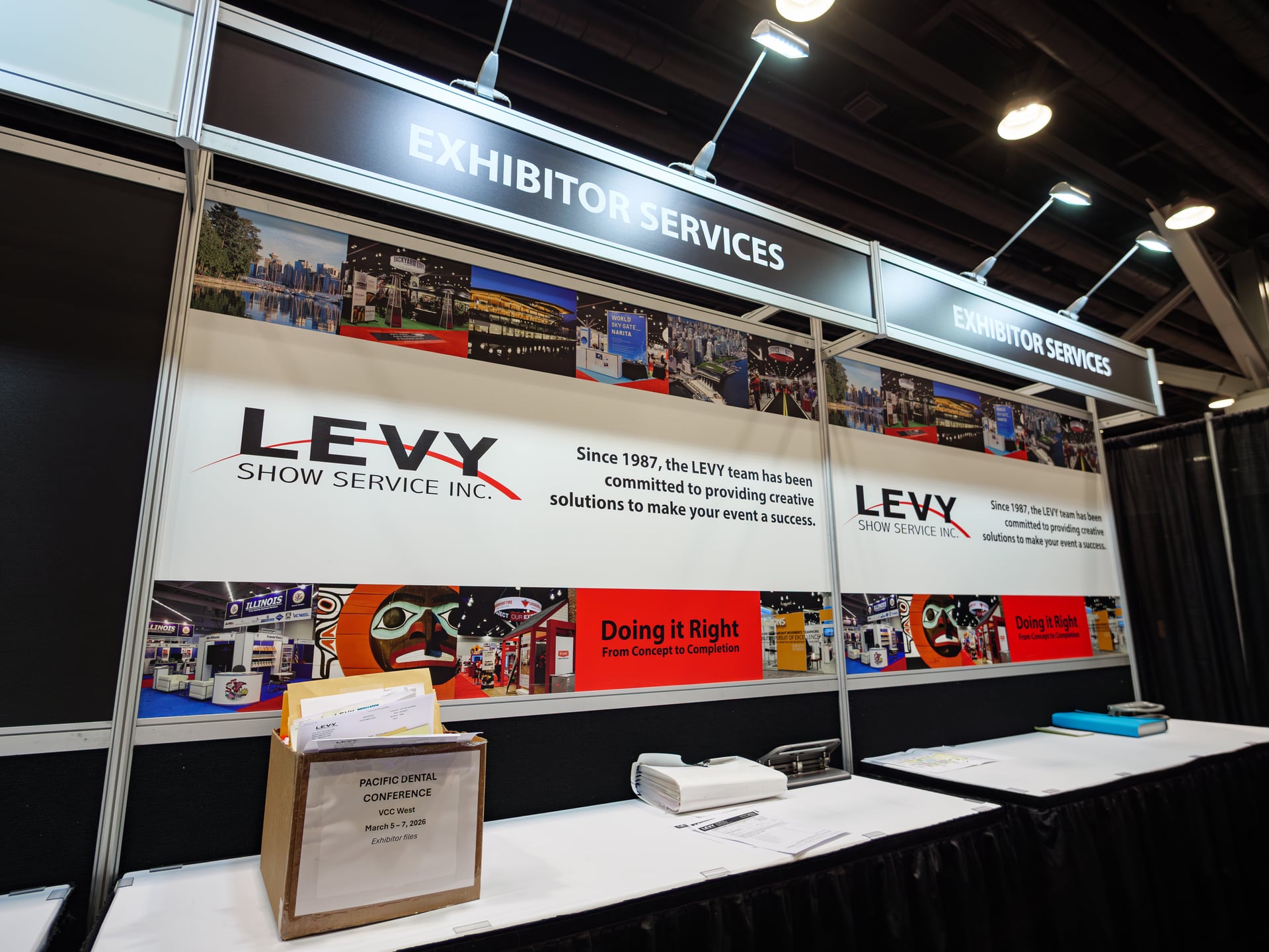The LEVY EXHIBITOR SERVICES booth at the show — large branded headers reading "Since 1987" and "Doing it Right · From Concept to Completion".
